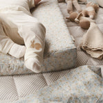 Tiny feet resting on a changing cushion nature trail