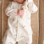 Little hands in a winter ski baby sleepsuit