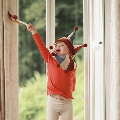 red and yellow jingling marotte played by a boy as jester