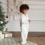 A boy wearing a nutcracker pyjamas while standing
