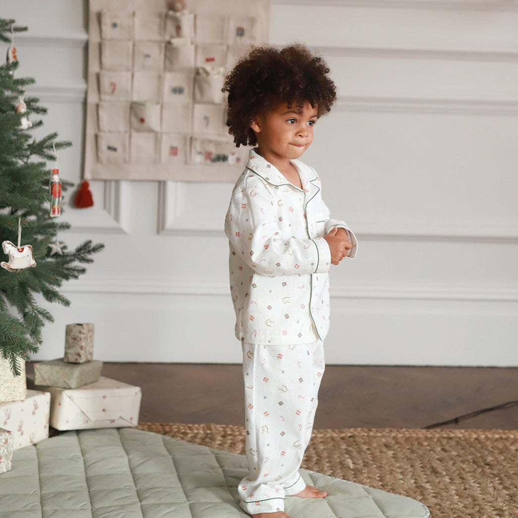 A boy wearing a nutcracker pyjamas while standing