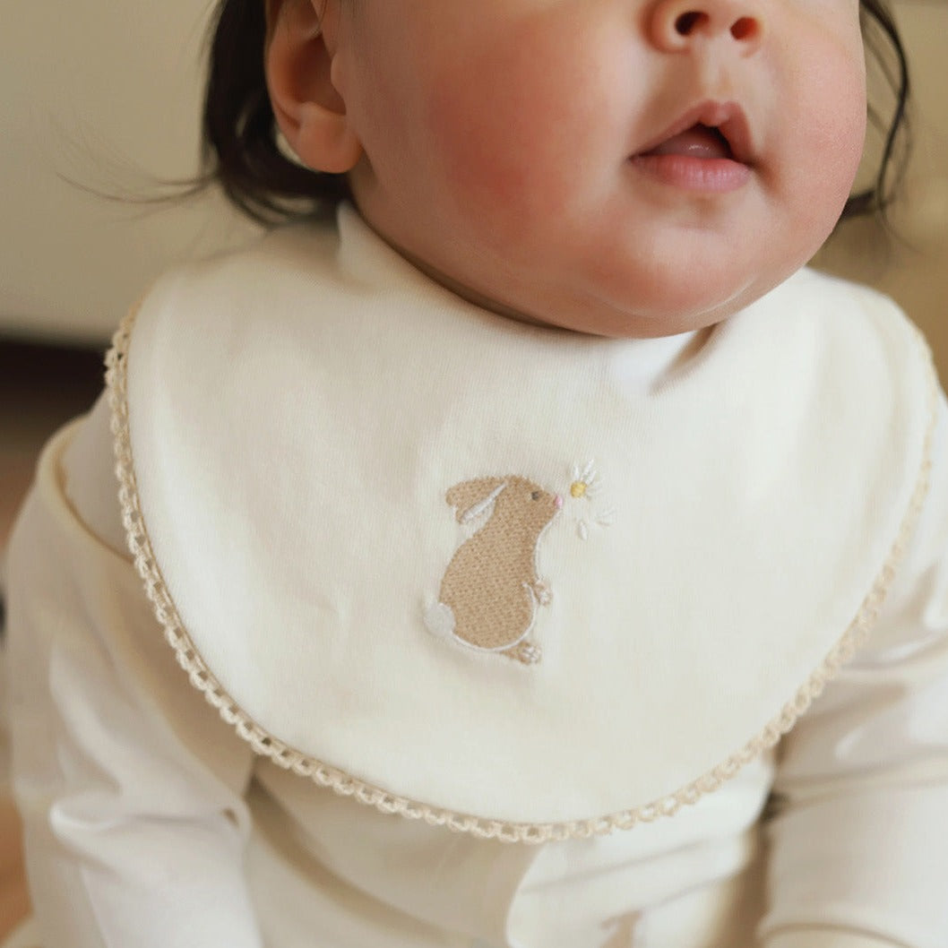 A cute Bunny Bib worn by a baby