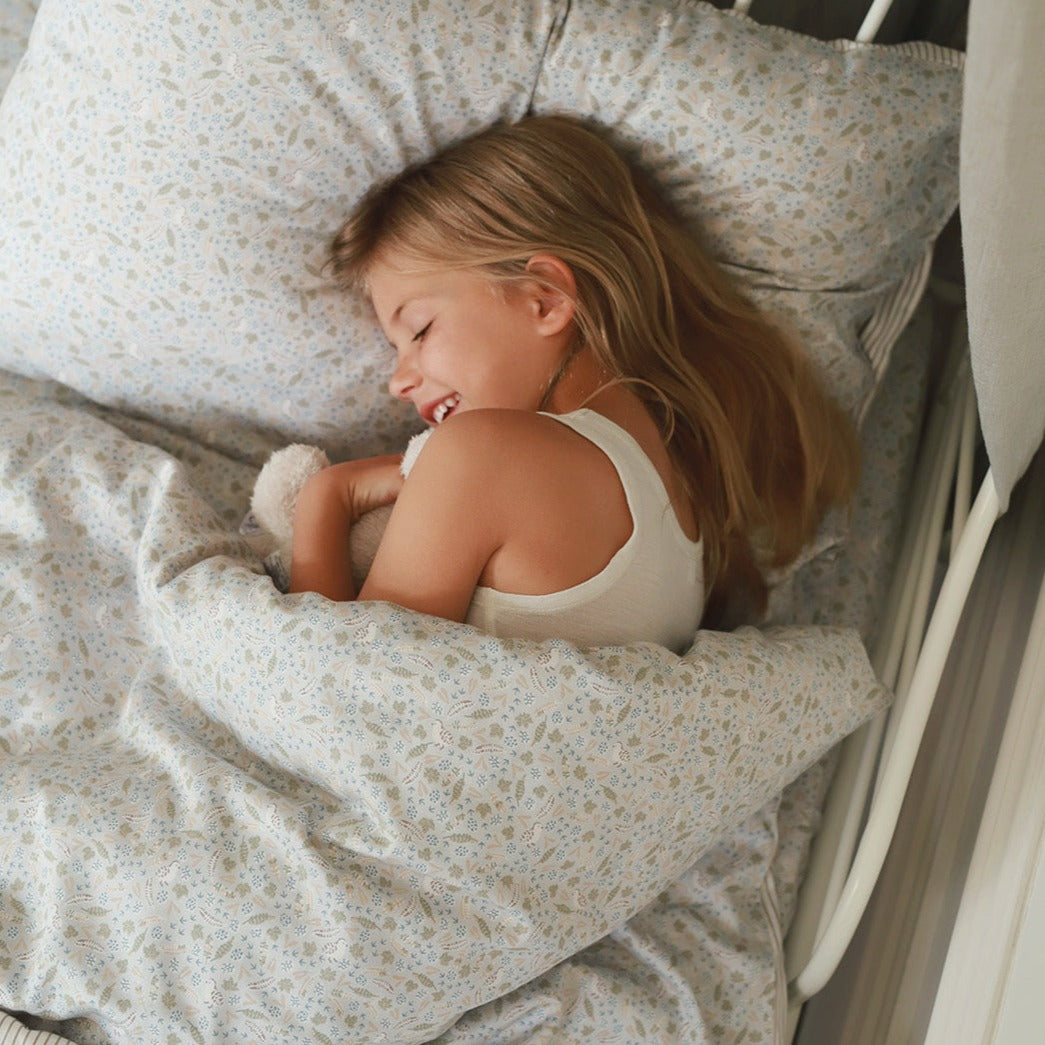 A girl getting comfy on a nature trail bedding set