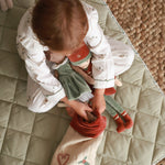 A girl putting the dolls inside a Christmas stocking