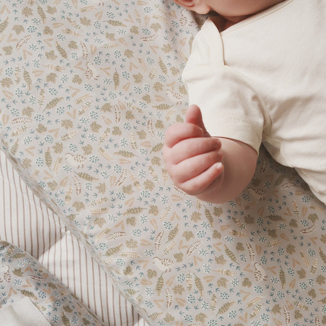 Little hands resting on a changing cushion nature trail