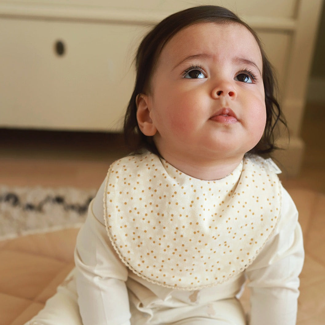 Baby wearing a daisy meadow bibs