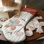 Christmas Stocking Gingerbread Man on top of a table with gingerbread and cookies