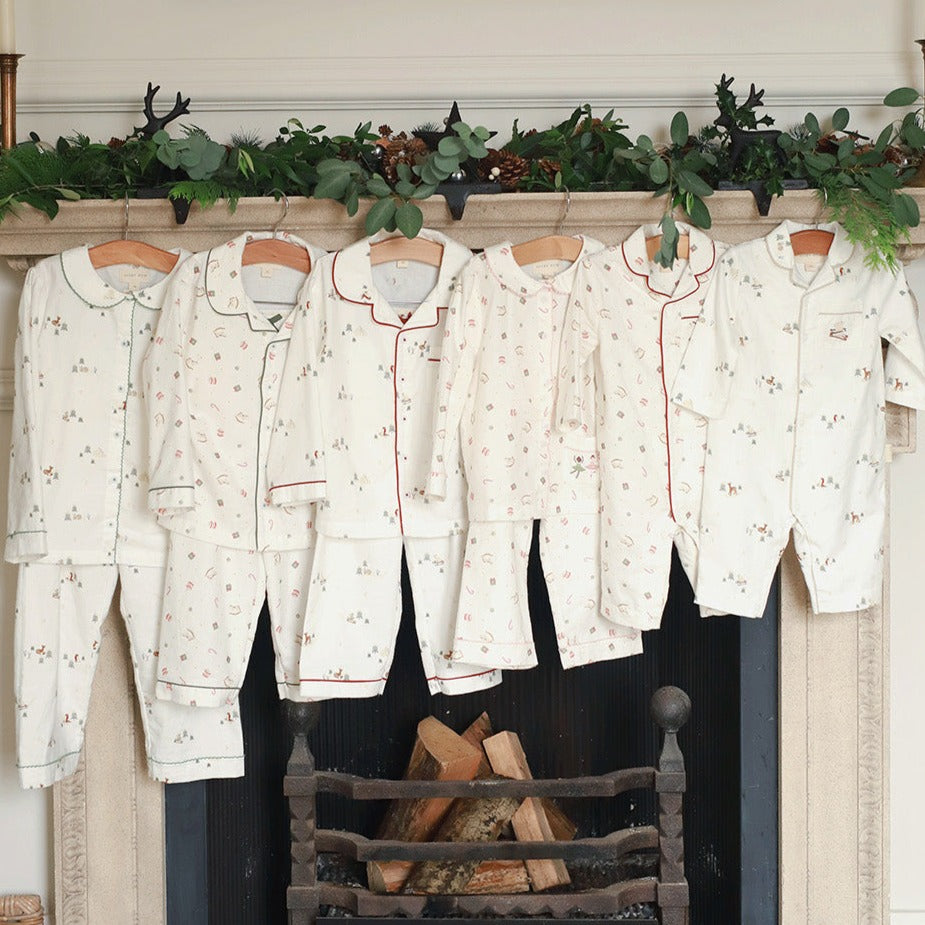 Collection of Christmas sleepsuits and pyjamas featuring baby sleepsuit in nutcracker design
