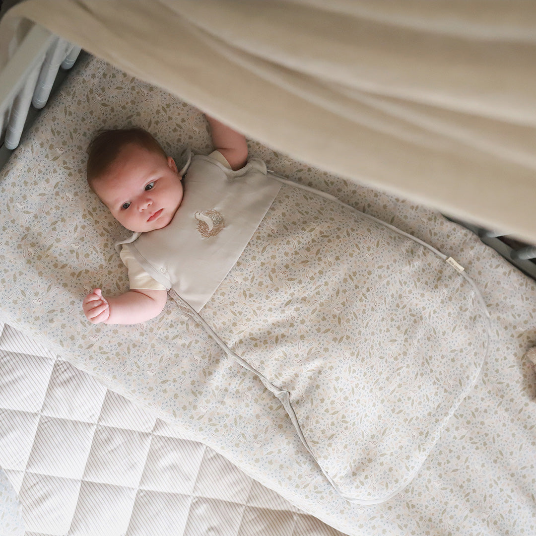 Cute baby wearing a sleeping bag in quail design