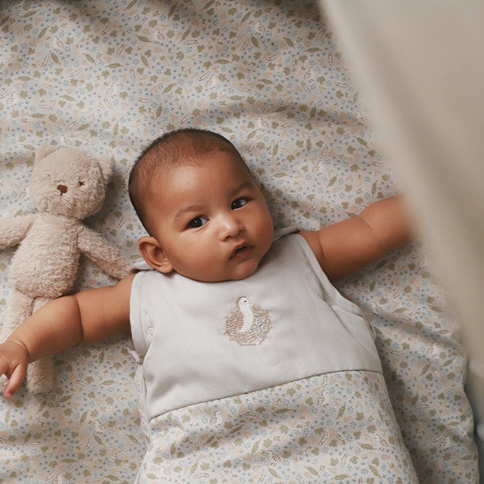 Sleeping bag quail worn by a baby