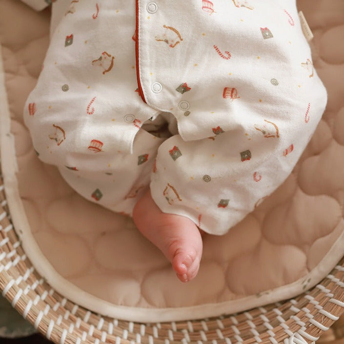 Tiny toes on a nutcracker baby sleepsuit