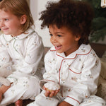 Two kids on a pyjamas eating gingerbread