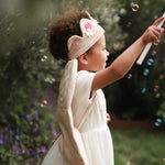 felt flower crown and canvas wings worn by a girl playing with bubbles