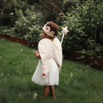 canvas wings and velvet flower fairy dress up worn by a girl in a garden with bubbles