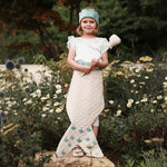 elegant 3 piece set contains a sea-blue velvet crown, pretty shell wand with a pop out pearl, and beautiful wrap around tail worn by girl standing