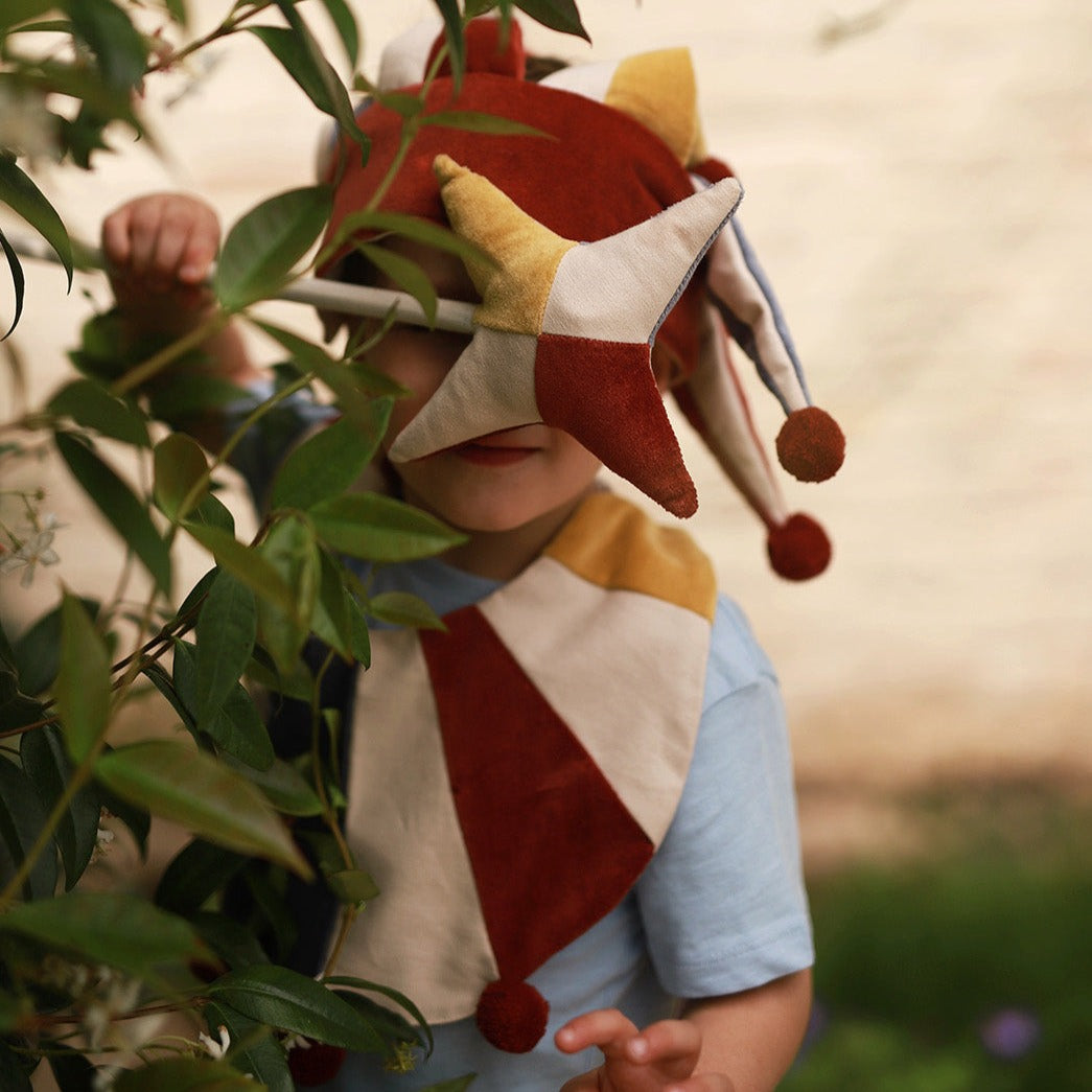 red, blue and yellow jingling marotte held by a kid playing 