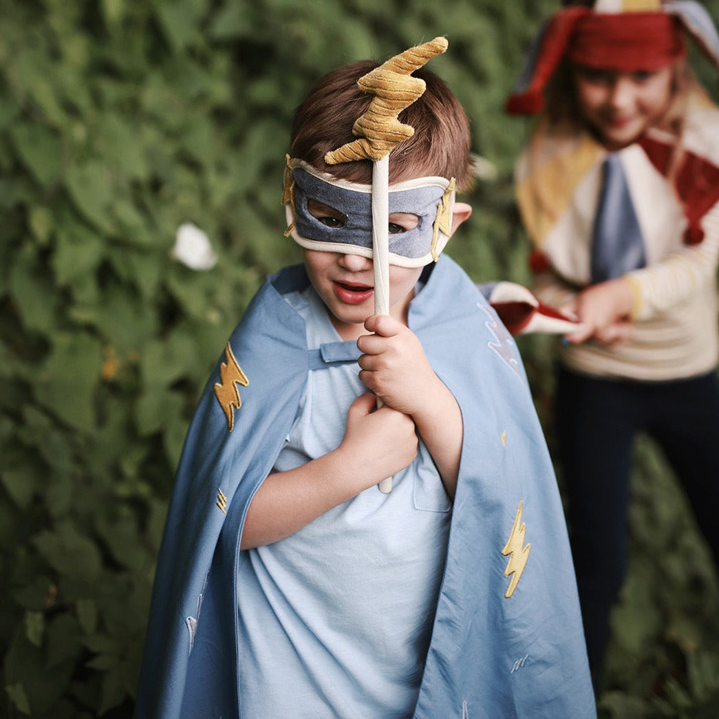 a boy with lightening bolt wand and velvet mask