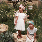 canvas wings and velvet flower fairy dress up worn by a girl in a garden